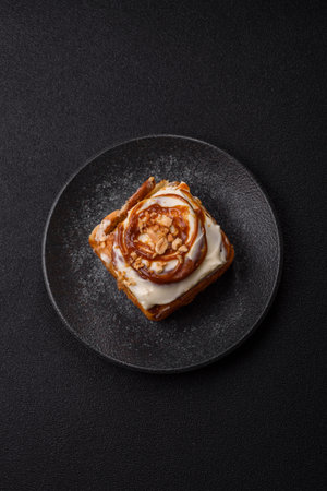 Cinnabon, a sweet cinnamon pastry, a high calorie bun or roll. Cinnabon with cinnamon as a food background for your designの写真素材