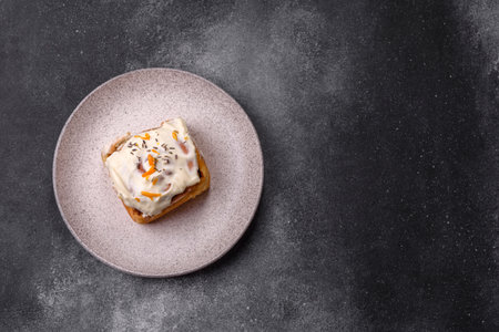 a sweet cinnamon pastry, a high calorie bun or roll. with cinnamon as a food background for your...