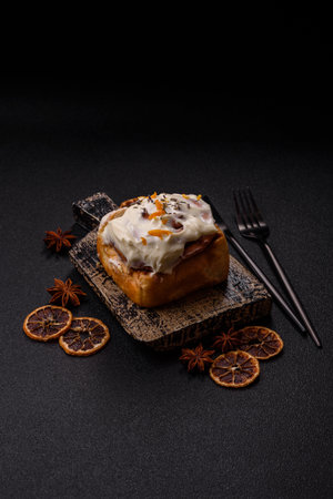 a sweet cinnamon pastry, a high calorie bun or roll. with cinnamon as a food background for your designの写真素材