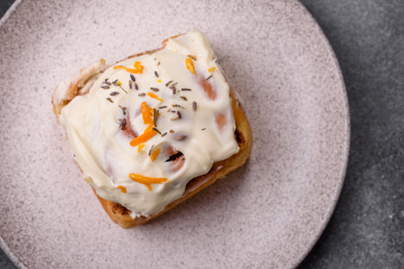 a sweet cinnamon pastry, a high calorie bun or roll. with cinnamon as a food background for your designの写真素材