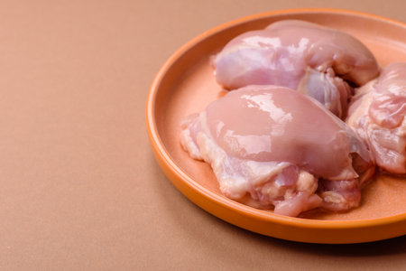 Chicken thigh fillet, skinless and boneless meat for grilling or barbecue. Chicken thigh fillet as a food background for your designの写真素材