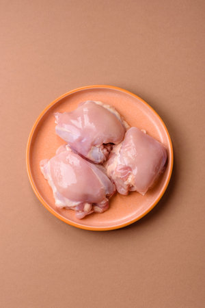 Chicken thigh fillet, skinless and boneless meat for grilling or barbecue. Chicken thigh fillet as a food background for your designの写真素材