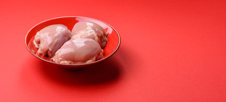 Chicken thigh fillet, skinless and boneless meat for grilling or barbecue. Chicken thigh fillet as a food background for your designの写真素材
