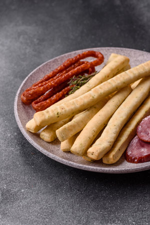 Grissini breadsticks, an Italian wheat pastry, are a great lunch snack. Grissini breadsticks as a food background for your designの写真素材
