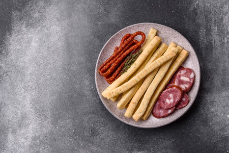 Grissini breadsticks, an Italian wheat pastry, are a great lunch snack. Grissini breadsticks as a food background for your designの写真素材