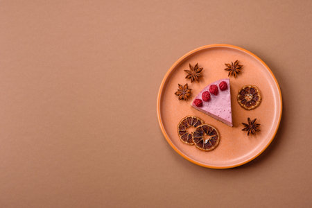 Raspberry or strawberry cheesecake, a slice of sweet red cake with berries. Raspberry cheesecake as a food background for your design.の写真素材