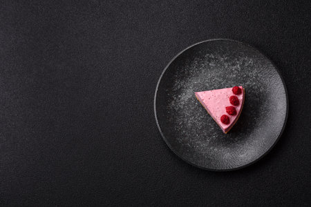 Raspberry or strawberry cheesecake, a slice of sweet red cake with berries. Raspberry cheesecake as a food background for your design.の写真素材