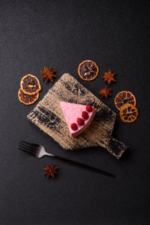 Raspberry or strawberry cheesecake, a slice of sweet red cake with berries.の写真素材