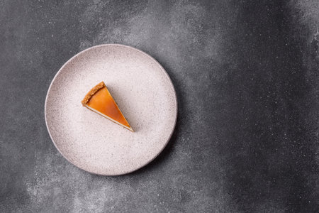 A slice of sweet pie, a classic cheesecake dessert. Cheesecake as a food background for your designの写真素材