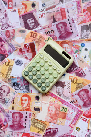 Calculator, money and expense calculations, tax form completion, and business budget concept preparation. Calculator, expense calculations as a financial background for your designの写真素材