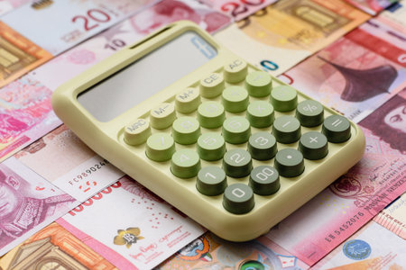 Calculator, money and expense calculations, tax form completion, and business budget concept preparation. Calculator, expense calculations as a financial background for your designの写真素材