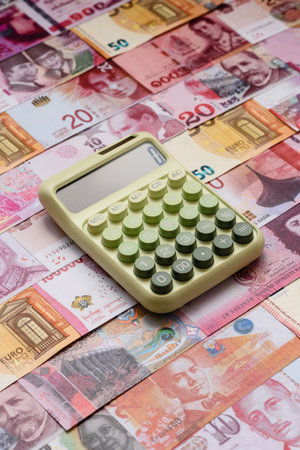 Calculator, money and expense calculations, tax form completion, and business budget concept preparation. Calculator, expense calculations as a financial background for your designの写真素材