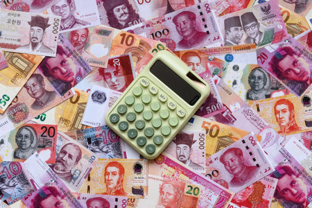 Calculator, money and expense calculations, tax form completion, and business budget concept preparation. Calculator, expense calculations as a financial background for your designの写真素材