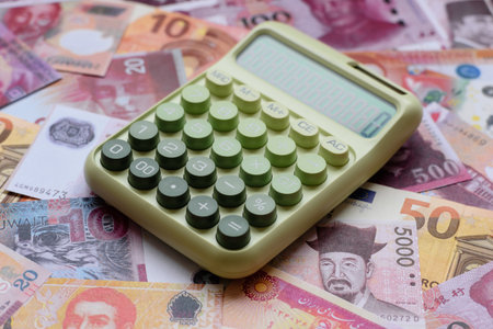 Calculator, money and expense calculations, tax form completion, and business budget concept preparation. Calculator, expense calculations as a financial background for your designの写真素材