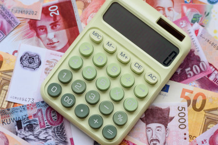 Calculator, money and expense calculations, tax form completion, and business budget concept preparation. Calculator, expense calculations as a financial background for your designの写真素材