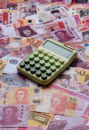 Calculator, money and expense calculations, tax form completion, and business budget concept preparation. Calculator, expense calculations as a financial background for your designの写真素材