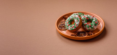 Christmas donuts or doughnuts, holiday winter sweets with chocolate filling and sprinkles. Christmas donuts or donuts as a food background for your design.の写真素材