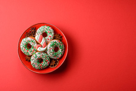 Christmas donuts or doughnuts, holiday winter sweets with chocolate filling and sprinkles. Christmas donuts or donuts as a food background for your design.の写真素材