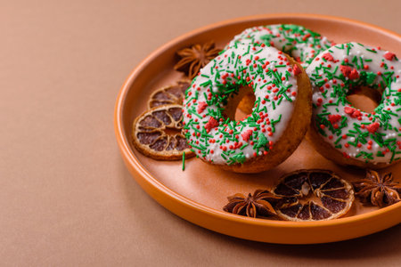 Christmas donuts or doughnuts, holiday winter sweets with chocolate filling and sprinkles. Christmas donuts or donuts as a food background for your design.の写真素材