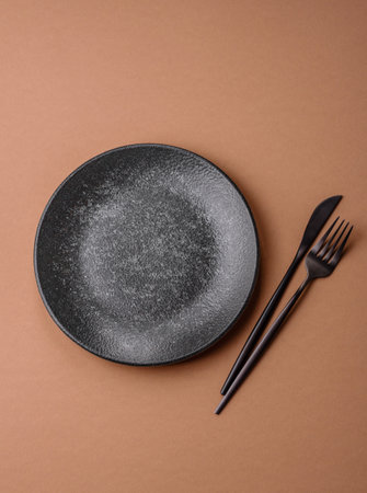 An empty round ceramic plate, kitchenware. An empty plate as a background for your designの写真素材