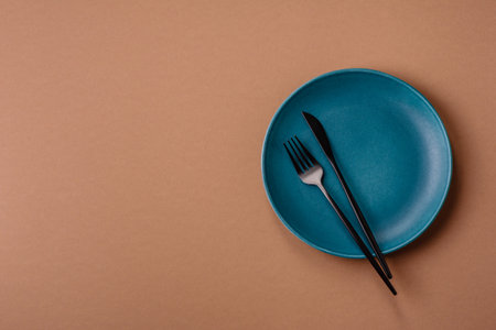An empty round ceramic plate on a table, kitchenware. An empty plate as a background for your designの写真素材