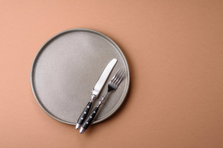 An empty round ceramic plate on a table. An empty plate as a food background for your designの写真素材