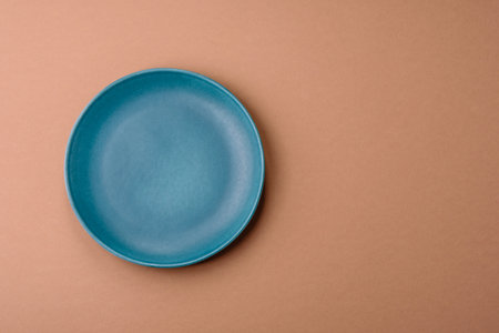 An empty round ceramic plate on a table. An empty plate as a food background for your designの写真素材