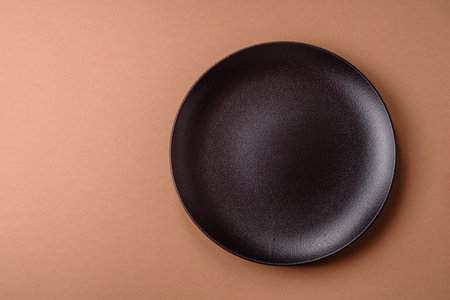 An empty round ceramic plate on a table. An empty plate as a food background for your designの写真素材