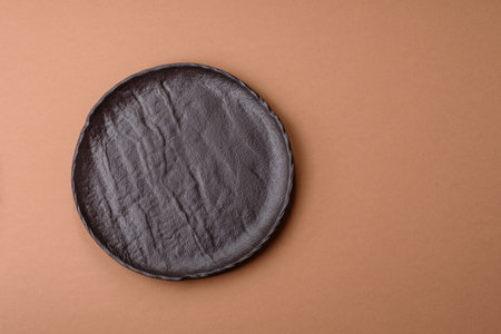 An empty round ceramic plate on a table, kitchenware. An empty plate as a food background for your designの写真素材