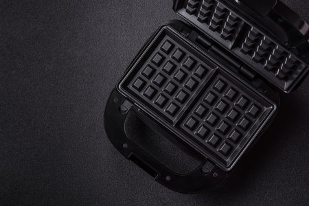 A waffle iron, an electric machine for making Belgian breakfast desserts. A waffle iron as a food...