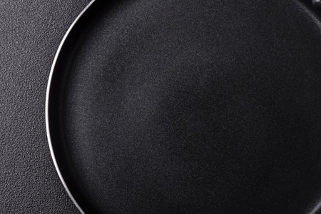 An empty black metal frying pan, kitchen utensils for cooking. An empty frying pan as a food...