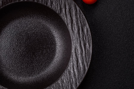 An empty round ceramic plate on a table, kitchenware. An empty plate as a food background for your designの写真素材