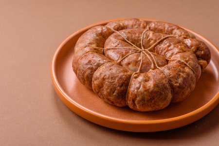 Grilled sausage in the shape of a spiral or snail, a meat dish made from chicken or pork with spices...