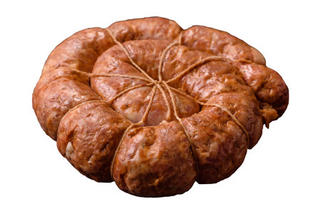 Grilled sausage in the shape of a spiral or snail, a meat dish made from chicken or pork with spices and herbs. Spiral or snail sausage as a food background for your designの写真素材