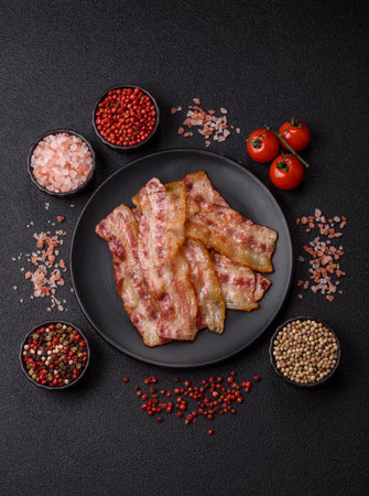 Fried smoked bacon slices, ham, jamon, or prosciutto strips for cooking. Fried bacon slices as a food background for your designの写真素材