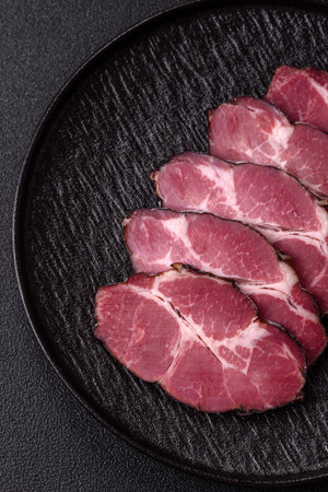 Meat, smoked ham, or pork sausage sliced for breakfast sandwiches. Sliced ham as a food background for your designの写真素材
