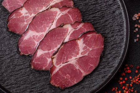 Meat, smoked ham, or pork sausage sliced for breakfast sandwiches. Sliced ham as a food background for your designの写真素材