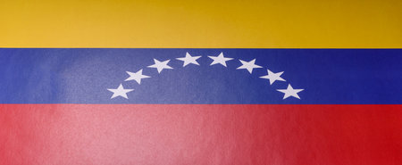 Venezuelan national flag in red, blue and yellow color as a symbol of independence. Flag of Venezuela as a background for your designの写真素材