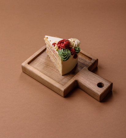 A slice of sweet layered cake with white cream for a birthday or holiday. A slice of cake as a food...
