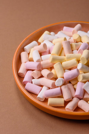Mini marshmallows in white, pink, and pastel colors, a colorful Christmas dessert. Marshmallows as a food background for your designの写真素材