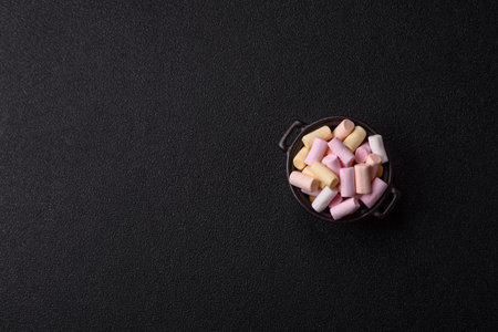 Mini marshmallows in white, pink, and pastel colors, a colorful Christmas dessert. Marshmallows as a...