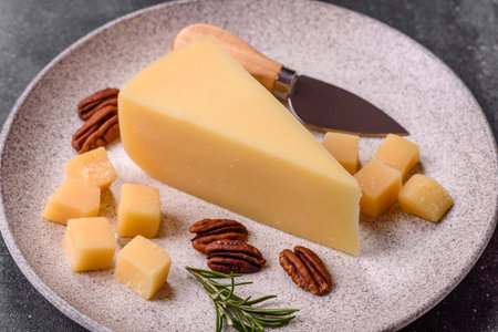 A wedge of cheddar, gouda, or parmesan cheese on a cutting board. Cheese wedge as a food background for your designの写真素材