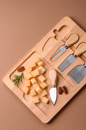 Cubed gouda or parmesan cheese on a cutting board. Cubed cheese as a food background for your designの写真素材