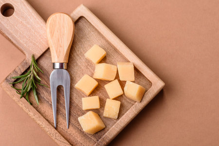 Cubed cheddar, gouda, or parmesan cheese on a cutting board. Cubed cheese as a food background for your designの写真素材