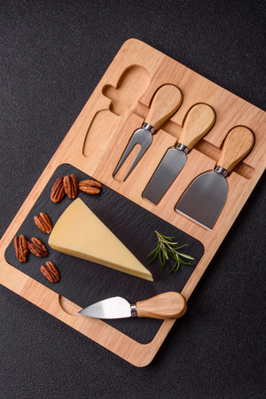 A wedge of cheese on a cutting board. Cheese wedge as a food background for your designの写真素材