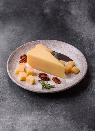 A wedge of cheese on a cutting board. Cheese wedge as a food background for your designの写真素材