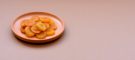 Dried apricots are a sweet, healthy fruit for vegans and vegetarians. Dried apricots as a food background for your designの写真素材