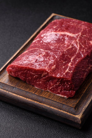 A piece of raw beef, a tenderloin for grilling or barbecue. Raw beef as a food background for your...