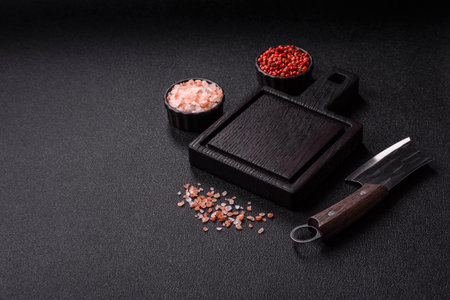 Empty wooden cutting board with a knife, salt, and spices for food preparation. An empty wooden...