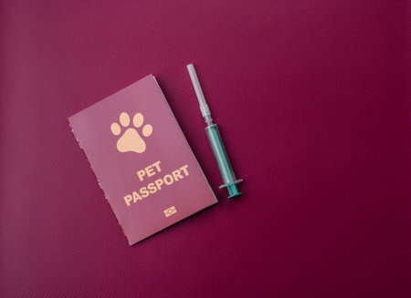 A pet passport is a document with vaccination and travel information for a cat, dog, or other animal. A pet passport as a background for your design.の写真素材